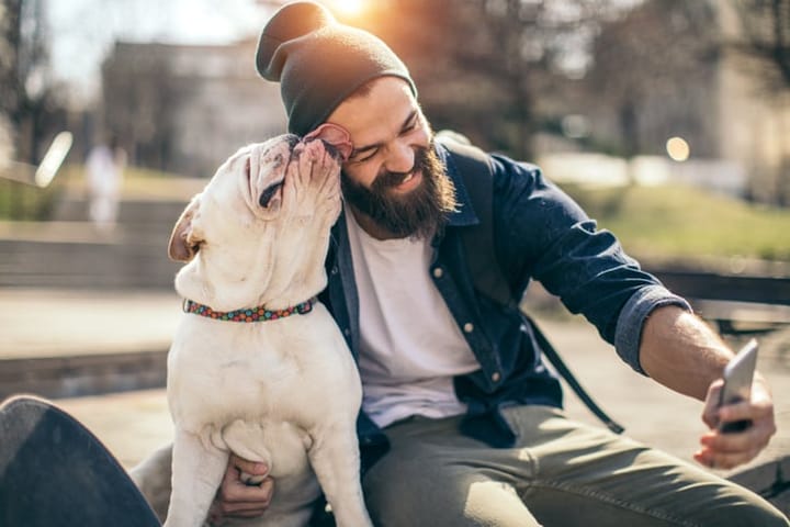 bearded guy smiling with dog