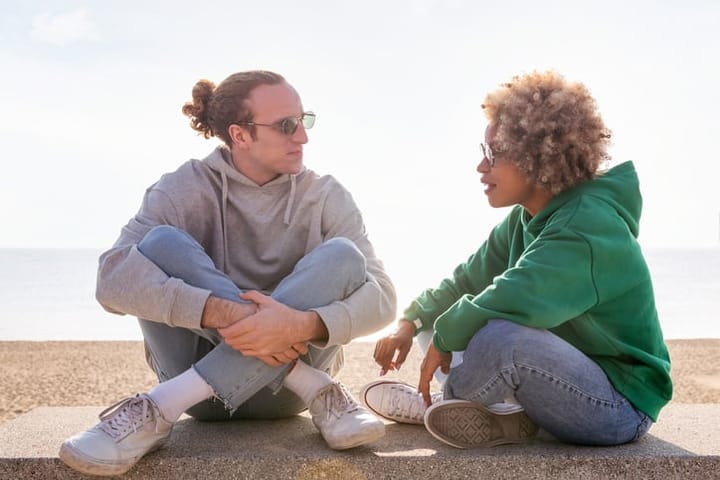 couple in sunglasses having chat
