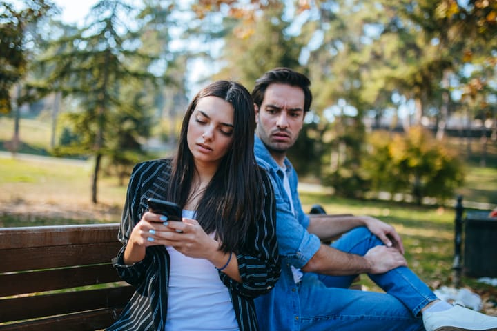 man looking at woman's texts