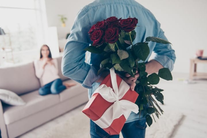 man hiding valentine's day gifts