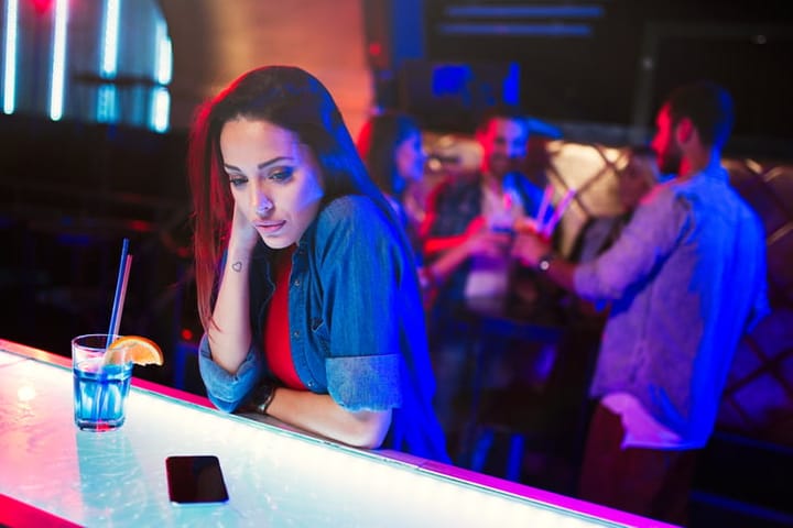 Woman sitting alone at bar