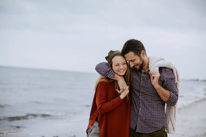 couple walking beach romance happy