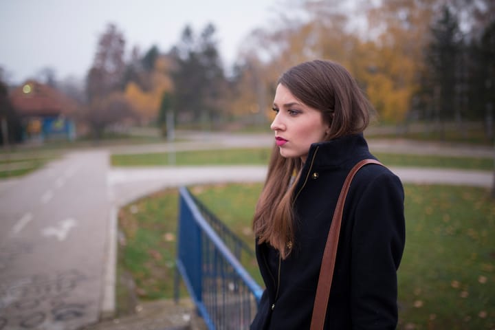 woman sad alone park fall
