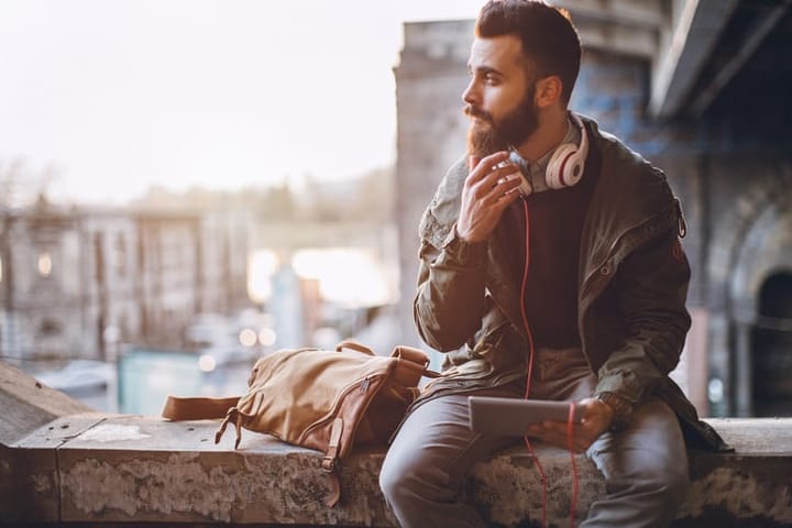 Man using digital tablet outdoors