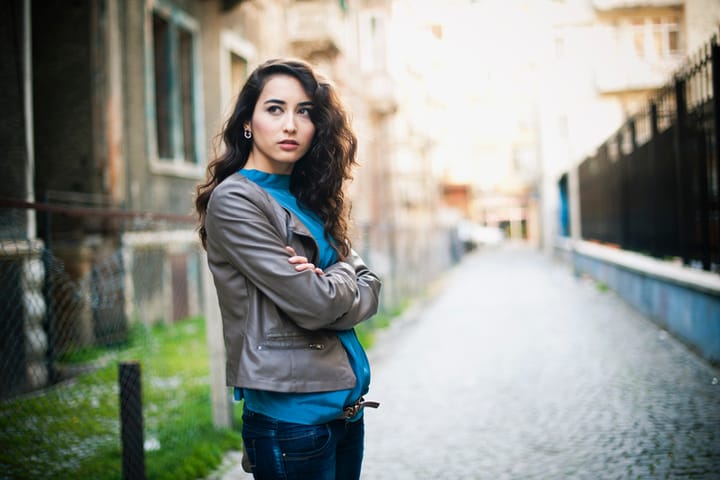 Alone, pensive young woman walking in the back streets.