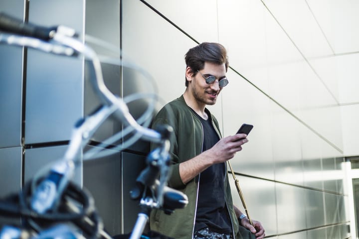 Hipster man with bike and phone