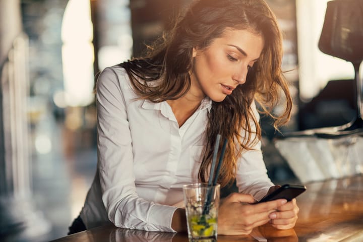 Beautiful woman looking at her phone.