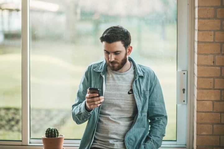 Man texting window