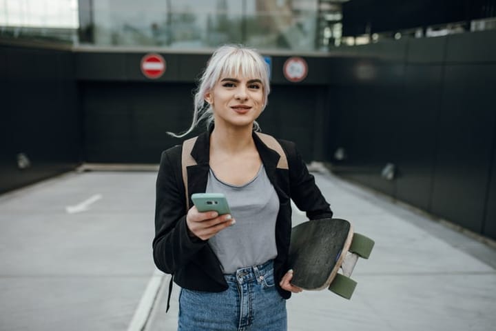 woman outside with skateboard