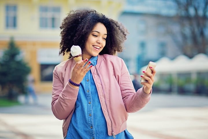 Happy woman eating ice cream.