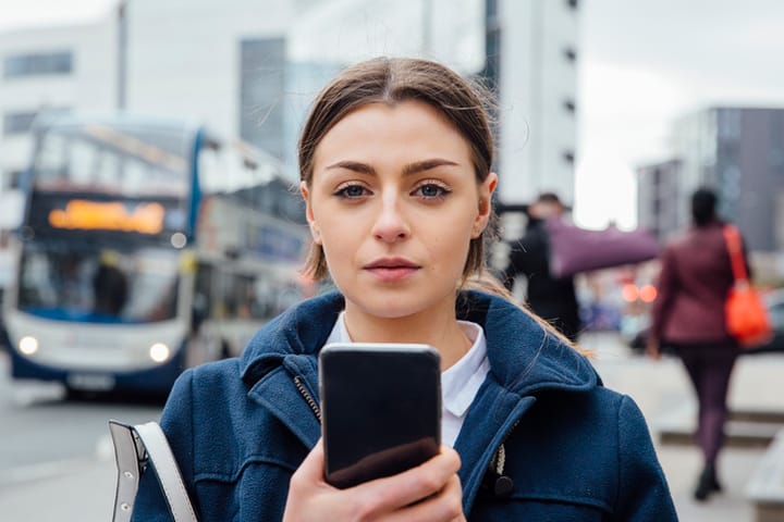 dark haired girl holding mobile