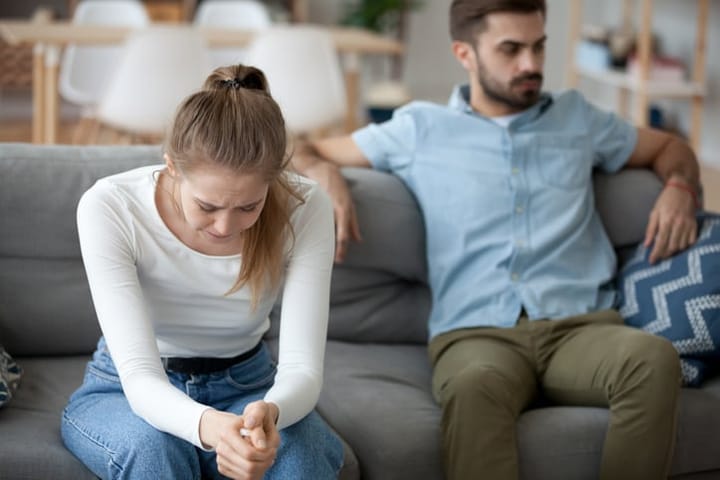 Unhappy married couple at home.