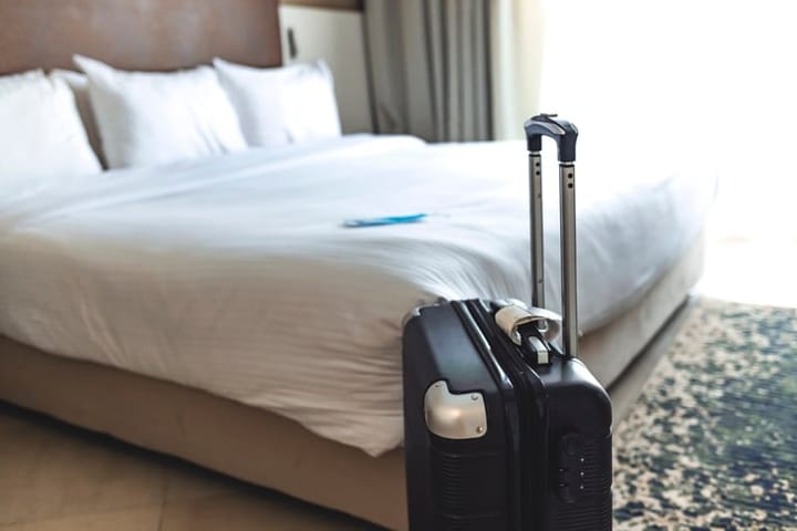Black suitcase in a hotel room.