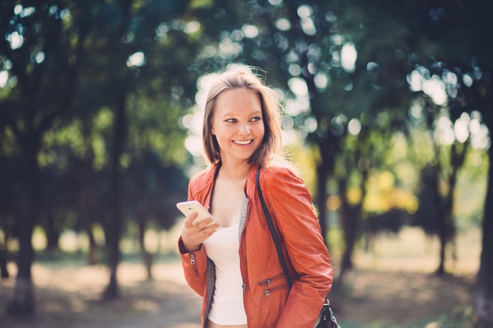 smiling happy woman orange jacket