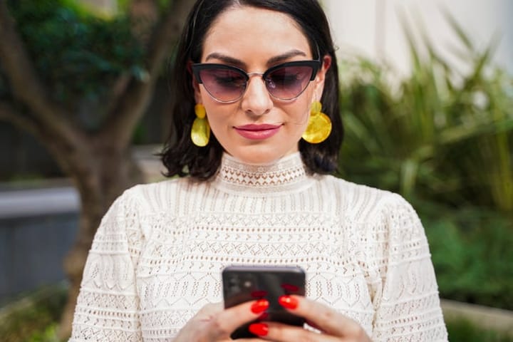 trendy woman holding smart phone