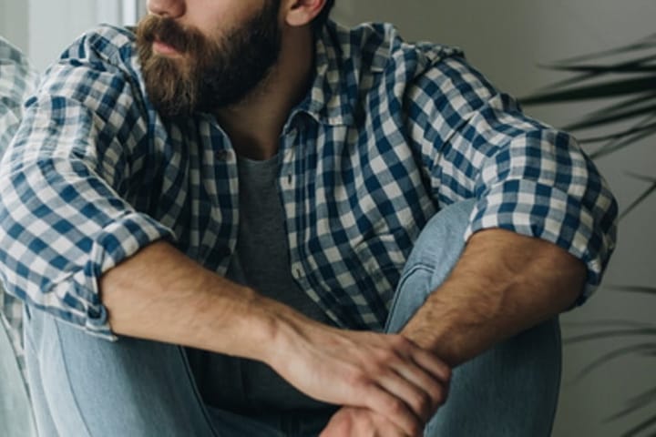 bearded man sitting down