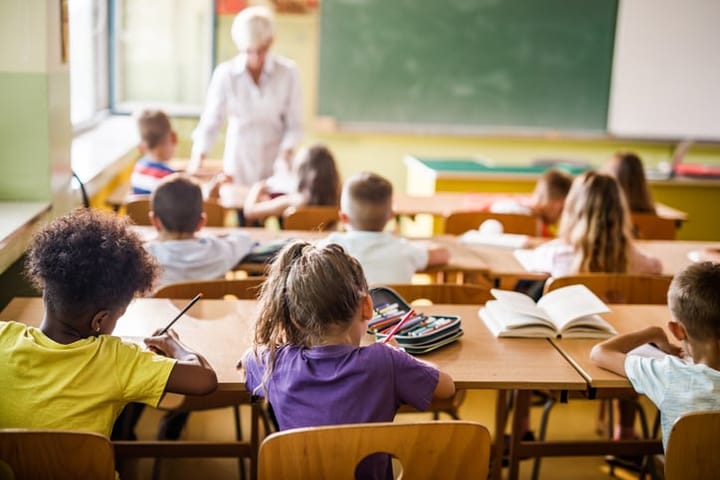 Elementary students attending a class.