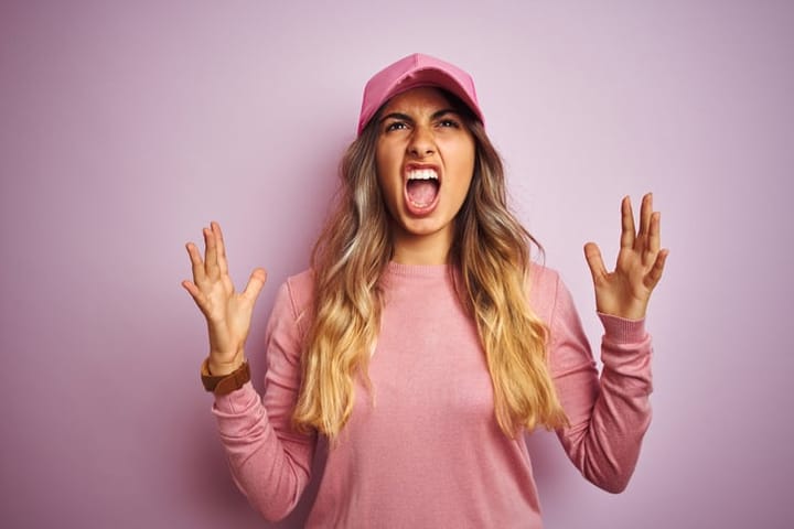 Young woman with a crazy expression on her face.