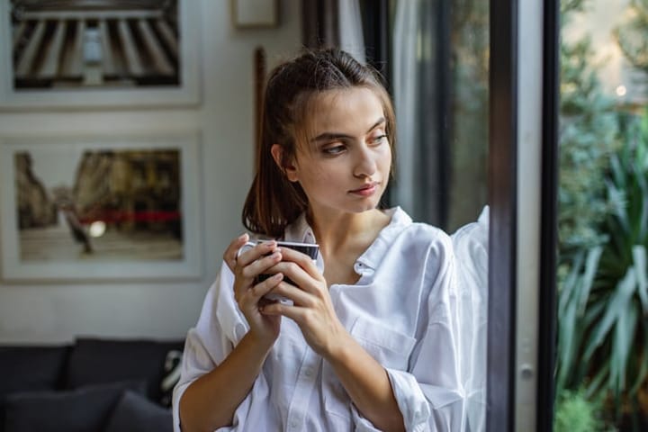 young woman looking out of the window