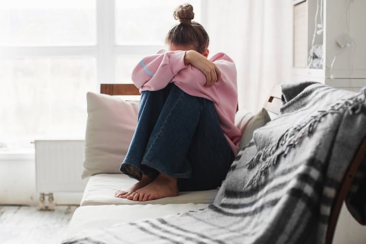 sad woman sitting on couch