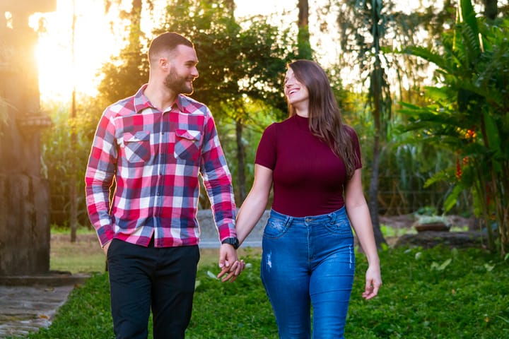 couple holding hands in park