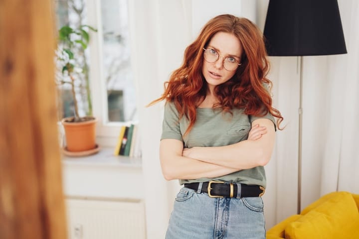 redhead with arms crossed at home