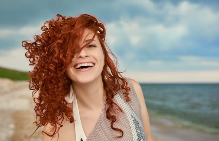 Ginger curly haired girl laughing