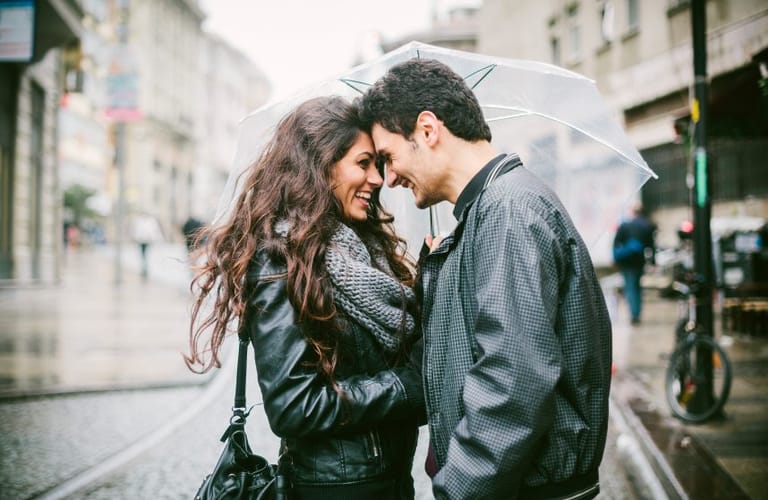 happy couple street umbrella