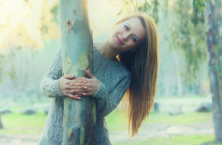 Woman standing with tree