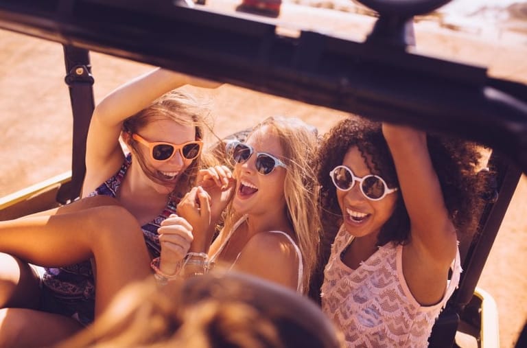 Mixed racial group of friends in car