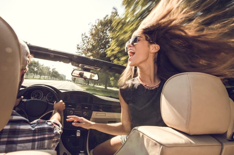 young cheerful woman in car