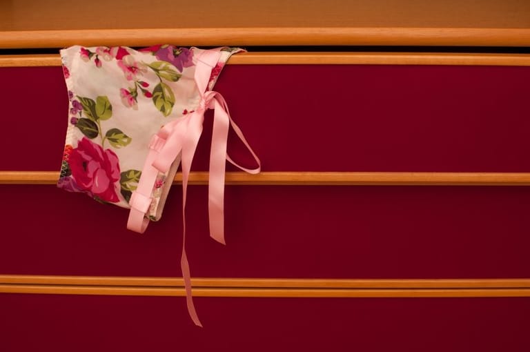 Lingerie hanging out of drawer