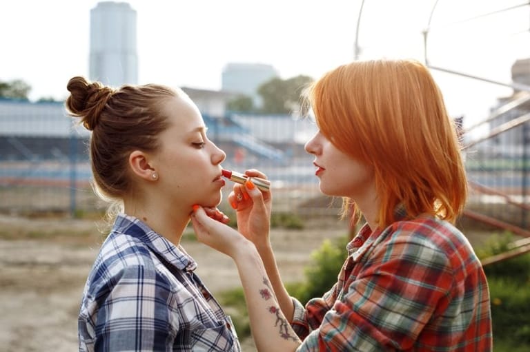 Women applying makeup.