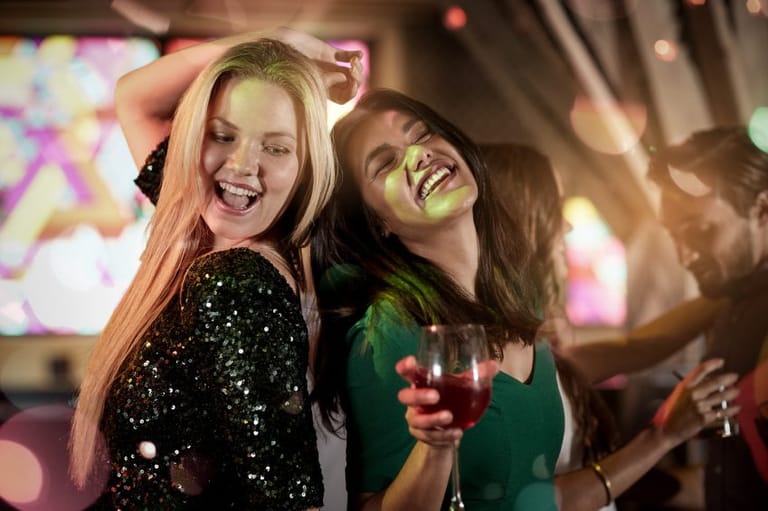 girls drinking wine at party