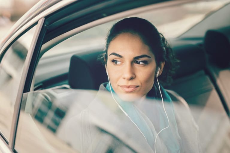 brunette looking out the window of a car