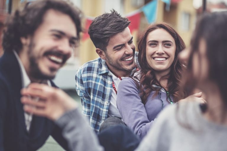 woman with guy friends laughing