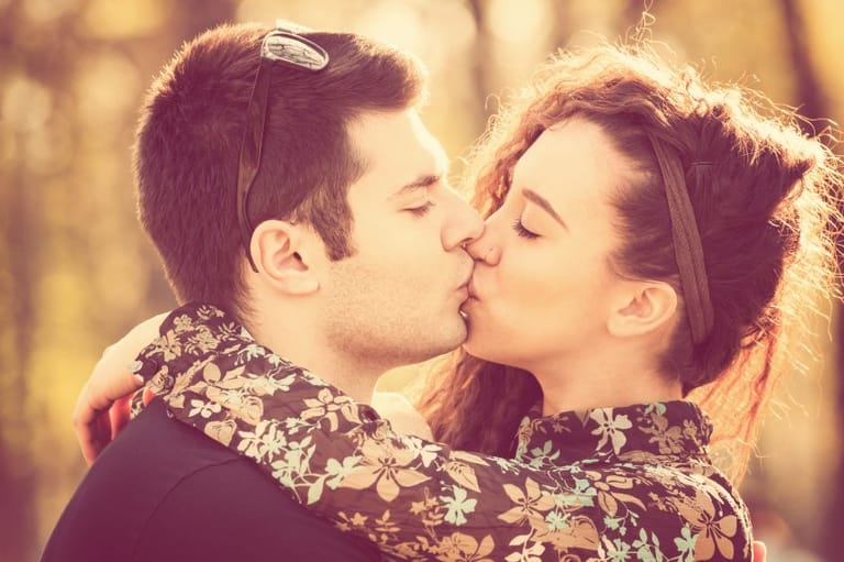 hipster couple kissing outdoors
