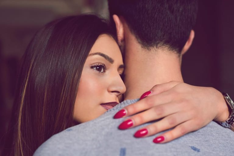 troubled woman embracing man