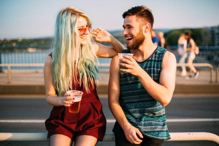 Hipster couple flirting on summer day.