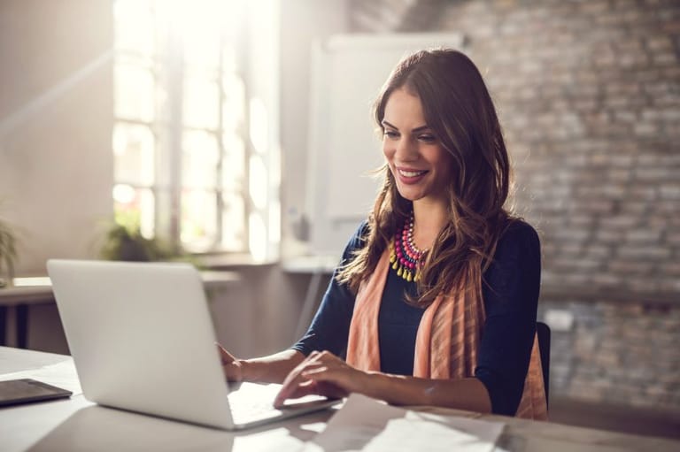 smiling businesswoman at laptop