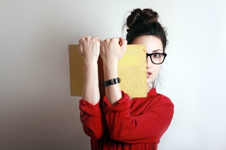Girl red sweater book glasses