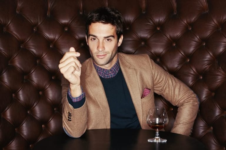 Guy sat in bar with wine
