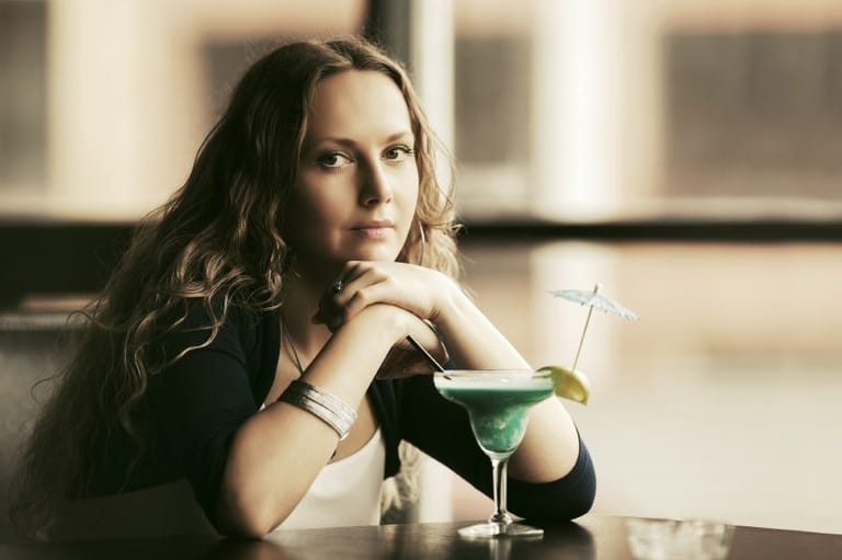 Woman waiting with cocktail