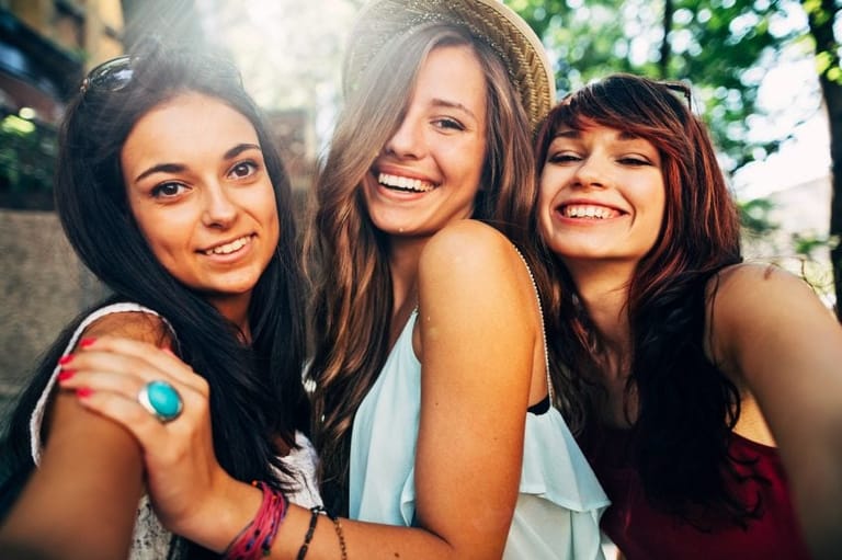 Three girlfriends laughing