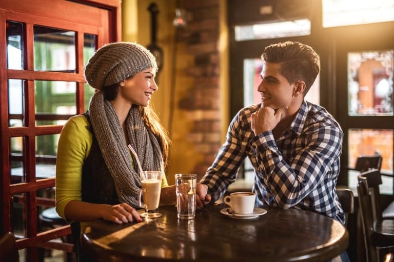Young couple in love sitting in a cafe
