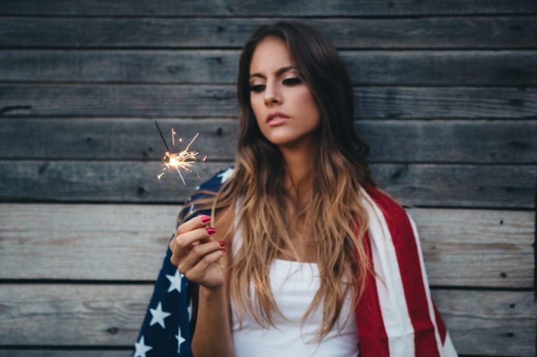 Girl with sparkler and american flag