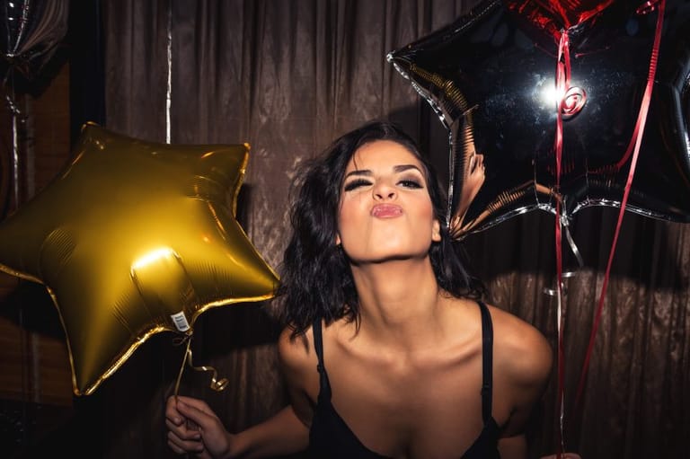 Woman with balloons partying