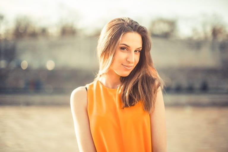 Beautiful model posing in sunset by the river