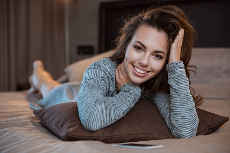 Pretty woman laying on bed