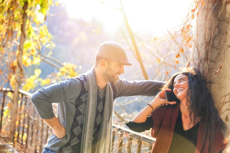 couple flirting near a tree